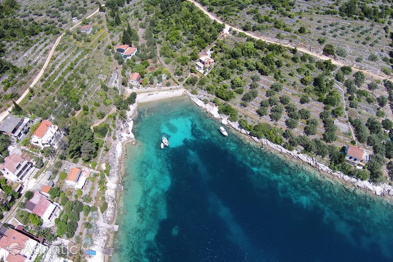 Calm white-pebble bay of Mikulina Luka below Villa Belveder, Vela Luka, Korčula